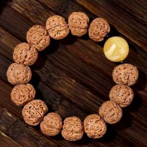 Exquisite Rudraksha Bracelet with Yellow Accent Bead, Featuring Intricate Textures and Traditional Style, Ideal for Jewelry Enthusiasts